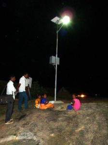 Girls studying under a solar-power lamp installed in their village by my organization.